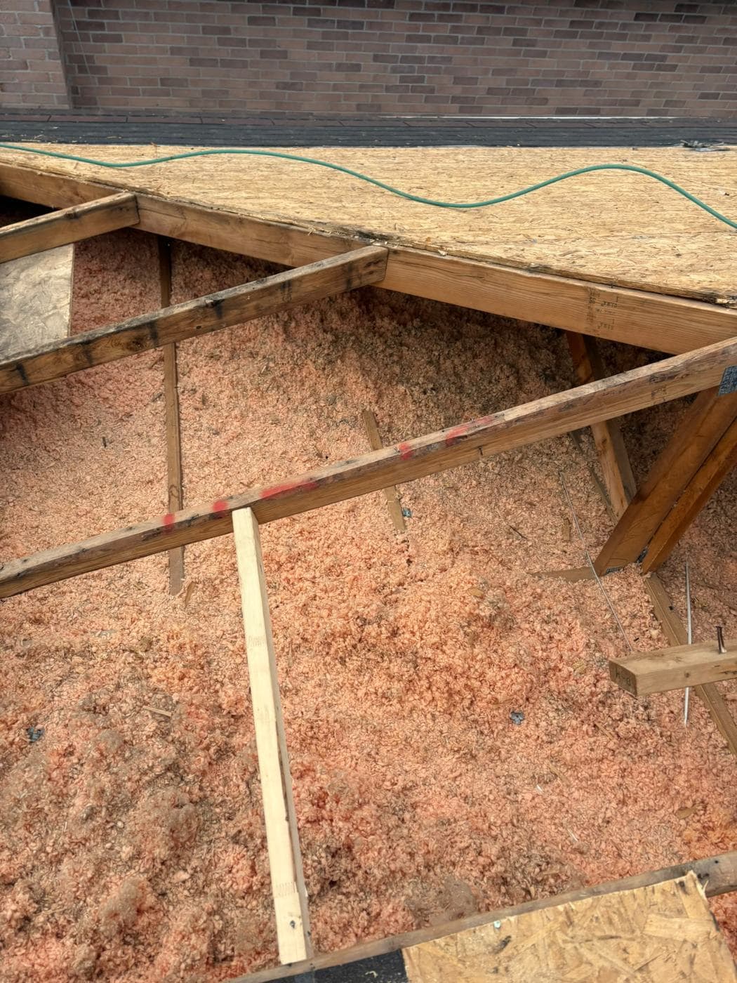 Attic insulation and framing during a roof replacement