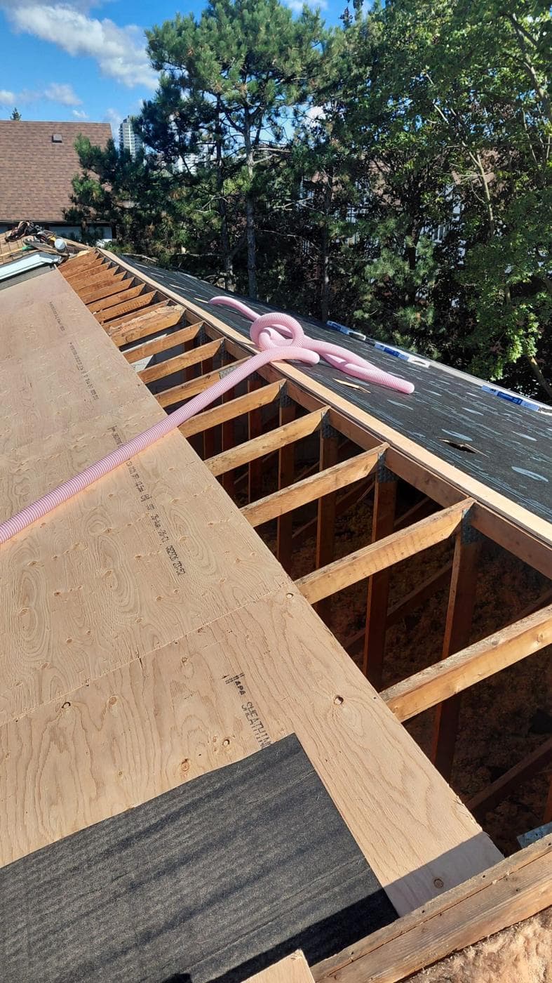 New roof deck with underlayment and open trusses
