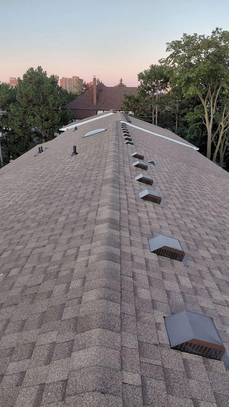 Finished brown shingle roof with ridge vents