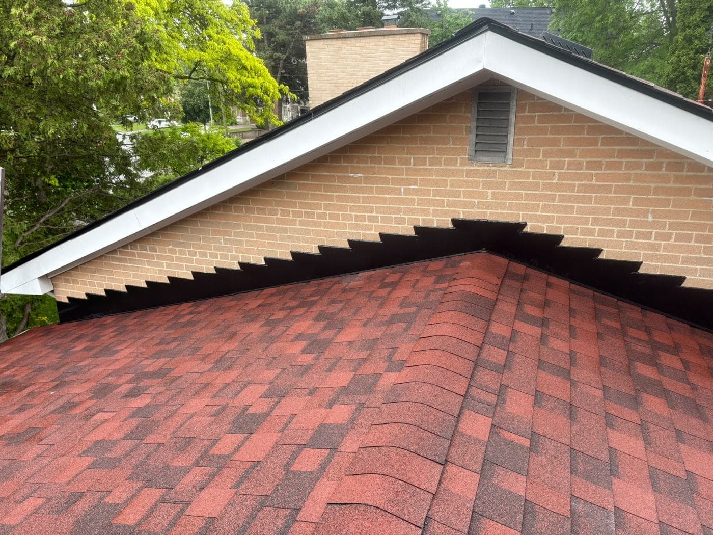 Finished red shingle roof at the gable end