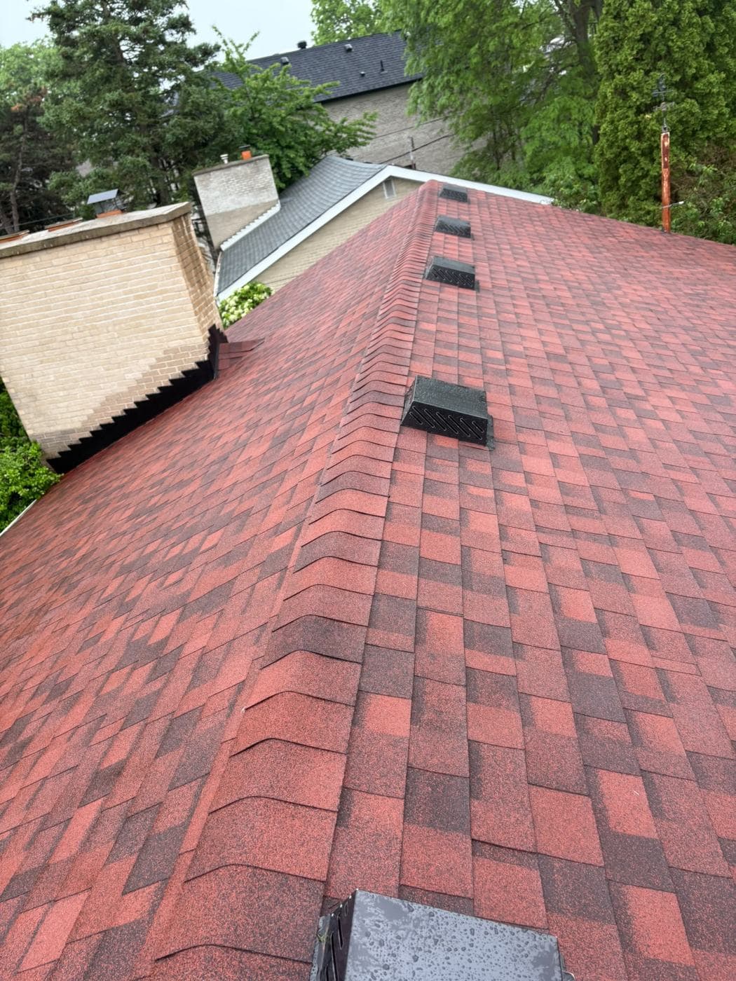 Finished red shingle roof with ridge vents