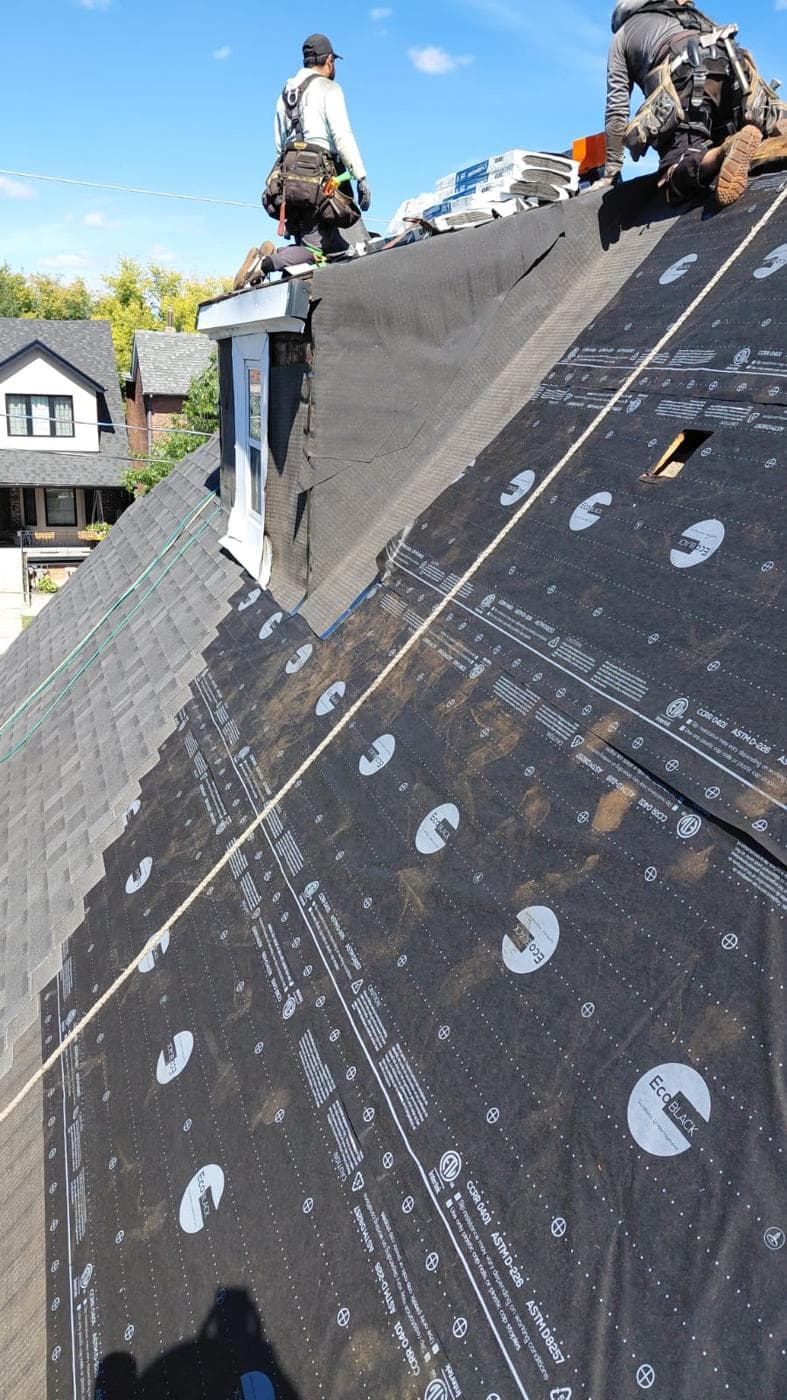 New underlayment and shingles being installed